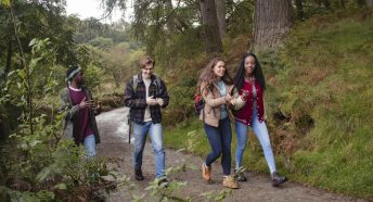 Young people walking in woodland